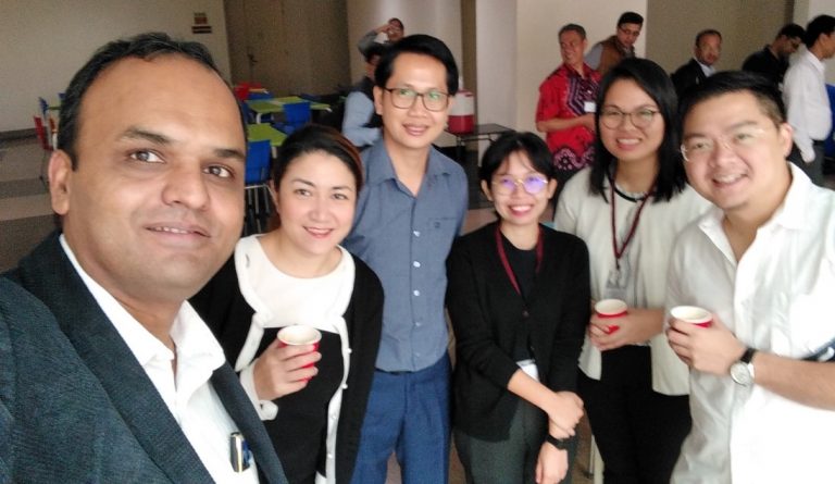 Dr. Phetsavanh Chanthavilay (center) and Mr. Nantasit Luangasanatip (far right) networking with other participants.